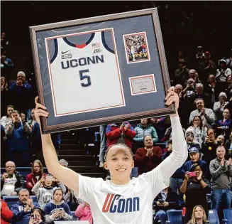  ?? Photos by Christian Abraham/Hearst Connecticu­t Media ?? UConn’s Paige Bueckers, above, is honored during Senior Night after Friday’s game against Georgetown in Storrs. Below, the Huskies also honored fellow seniors, from left, Aaliyah Edwards, Aubrey Griffin and Nika Mühl.