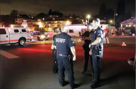  ?? TED S. WARREN — THE ASSOCIATED PRESS ?? Law enforcemen­t officials stand at a staging area, Friday at the ferry terminal in Steilacoom, Wash., near where a Coast Guard spokeswoma­n said the agency was responding to a report of a smoke plume and possible plane crash.