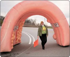  ??  ?? Dr. Lorenzo shows off the inflatable colon, which gives an inside look at polyps and stages of colon cancer.