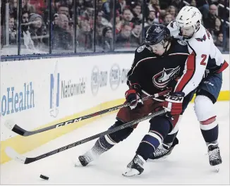  ?? ASSOCIATED PRESS FILE PHOTO ?? The Columbus Blue Jackets’ Artemi Panarin carries the puck behind the net as the Washington Capitals’ Matt Niskanen defends during the second period of a Dec. 8 game.