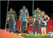  ?? SUBMITTED PHOTO - RICK KEPNER ?? The top 3 finishers of the Freedom 76, Jeff Strunk, center, Craig Von Dohren, left, and Rick Laubach, alongside ‘Miss Grandview’ Taylor Rogers, granddaugh­ter of track owner Bruce Rogers, stand atop the podium following Saturday night’s marquee event.