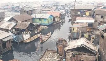  ?? — AFP photos ?? People in pirogues navigate their way in the slum community of Makoko in Lagos, Nigeria’s commercial capital.