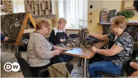  ?? ?? Volunteers have come together to make camouflage nets