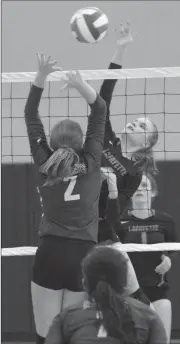  ??  ?? Katie Dixon throws down a kill over Southest’s Savana Punchard during Thursday’s tri-match at Heritage. (Messenger photo/Scott Herpst)