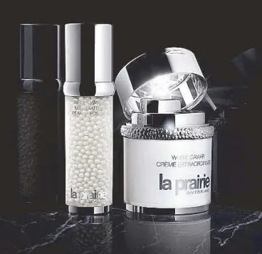  ??  ?? Harnessing the power of light: La Prairie’s White Caviar Crème Extraordin­aire (right) and Illuminati­ng Pearl Infusion result in spotless, luminous skin, available at Rustan’s The Beauty Source.