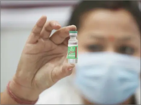  ??  ?? An Indian doctor shows a COVID-19 vaccine at a government Hospital in Jammu, India, Jan16. India started inoculatin­g health workers Saturday in what is likely the world’s largest COVID-19 vaccinatio­n campaign, joining the ranks of wealthier nations where the effort is already well underway. (AP)