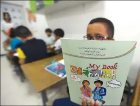  ?? (File Photo/AP/Fateh Guidoum) ?? A child shows his English lessons book Sept. 21, 2022, at a private school in Birkhadem.