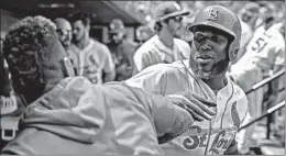  ?? SCOTT KANE/GETTY ?? Marcell Ozuna celebrates with teammate Carlos Martinez after his three-run homer.