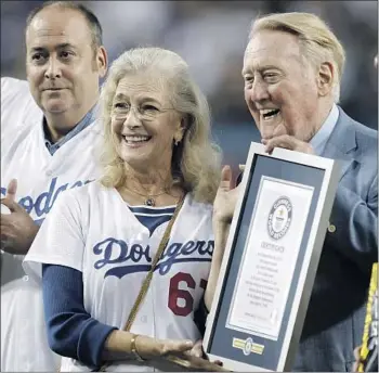  ?? Alex Gallardo Associated Press ?? VIN SCULLY, alongside his wife, Sandi, was honored before a 2015 game. The ex-broadcaste­r, 93, says of Sandi’s Jan. 3 death: “I’ve been severely wounded, but I’ve also come to grips with it . ... It’s all God’s plans.”