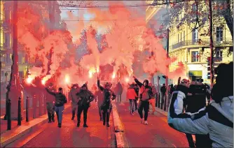  ?? AFP ?? Protesters wave flares during a rally called by trade unions against the government pension reform plan in Marseille, France.