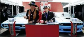  ?? MATT SLOCUM — THE ASSOCIATED PRESS ?? In this photo, Richard Petty, left, smiles while signing autographs with his grandson, Thad Moffit at a sponsor’s event during the NASCAR Cup Series Pocono 400auto race weekend in Long Pond, Pa.