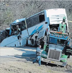  ?? JOSH BRIGGS THE ASSOCIATED PRESS ?? The bus was carrying a youth football team from Tennessee when it rolled off an interstate off-ramp and overturned before sunrise Monday. The elementary-school age football team from Orange Mound Youth Associatio­n in southeast Memphis had played in a tournament in Dallas over the weekend.