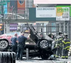  ?? DREW ANGERER/GETTY IMAGES ?? A wrecked car is seen in New York’s Times Square on Thursday after a man drove onto the sidewalk, killing one person and injuring 20 others.