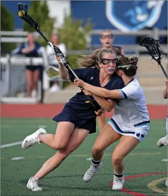  ?? STUART CAHILL — BOSTON HERALD ?? Notre Dame Academy’s Emma Connerty drives into Franklin’s Kate O’Rourke, right, as Franklin takes on Notre Dame in girls lacrosse action on May 18, 2022in Franklin. Connerty will play in college at North Carolina.