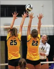  ??  ?? Avon’s Katie Sopko returns the ball at the net and over the defense by Lauren Kreitzer and Jeanie Edgington of Olmsted Falls.