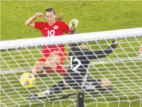  ?? GREGG NEWTON / AFP VIA GETTY IMAGES ?? Canada’s Sarah Stratigaki­s nudges the ball past goalkeeper Solana Pereyra of Argentina for the game’s only goal at the Shebelieve­s Cup
tournament in Orlando, Fla., on Sunday.