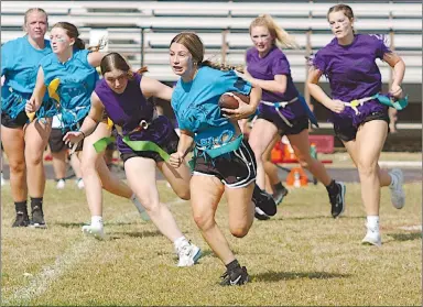  ?? Westside Eagle Observer/RANDY MOLL ?? Audrie Littlejohn (a sophomore) carries the ball, while juniors Shelby Still, Payge Deason and Reese Hester pursue during Wednesday’s powderpuff football game in Gentry. Sophomores Kayla Summers and Makena Womack are in the background to the left.