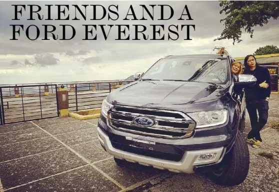  ??  ?? Tagaytay high: Author Kathy Moran and Igan D’Bayan with the Ford Everest, with the light afternoon rain giving the view of Taal Lake a splendorou­s bluish hue. The Everest handled the three-and-hour drive to Tagaygay with ease.