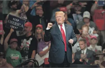  ?? Scott Olson Getty Images ?? PRESIDENT TRUMP speaks to supporters in Elkhart, Ind., in 2018. At Saturday’s indoor rally in Tulsa, his admirers will sing, whoop and shout — all highly efficient means of propelling the coronaviru­s into the air.