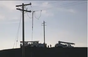  ?? Paul Kuroda / Special to The Chronicle ?? PG&E crews work in Sonoma to restore electricit­y after the wildfires. The utility will probably be held liable for damages, whether or not it was at fault.
