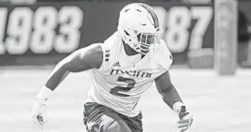  ?? SUSAN STOCKER/SOUTH FLORIDA SUN SENTINEL ?? Miami defensive lineman Quincy Roche runs a drill during the first day of spring practice.