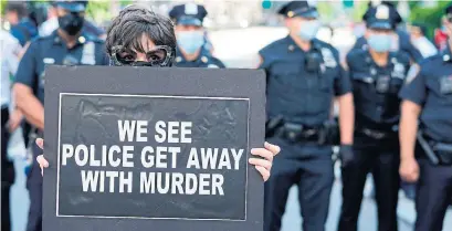  ?? TIMOTHY A. CLARY AFP VIA GETTY IMAGES ?? A demonstrat­or protests police brutality and the death of George Floyd in New York City.