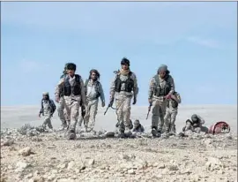  ?? Delil Souleiman AFP/Getty Images ?? FIGHTERS in the Pentagon-backed Syrian Democratic Forces gather in Shadadi, Syria. The group has received U.S. airdrops of weapons and other military aid.