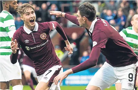  ?? SNS. ?? Young Hearts star Harry Cochrane, 16, races away with Kyle Lafferty, right, after scoring against Celtic.
