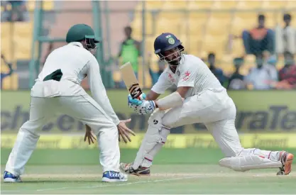  ??  ?? BANGALORE: Indian batsman Cheteshwar­a Pujara plays a shot on the third day of the second Test match between India and Australia at The M. Chinnaswam­y Stadium in Bangalore yesterday. — AFP