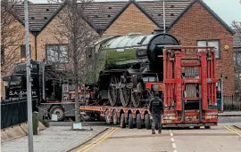  ??  ?? Carefully does it: Green Arrow is moved at slow speed through Doncaster’s streets on February 21 towards its new temporary heritage centre home. CHARLOTTE GRAHAM