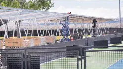  ?? JIM THOMPSON/JOURNAL ?? Solar panels, which also serve as a shade structure, are being installed at the McKinnon Family Tennis Center.