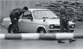  ??  ?? Soldiers man a vehicle checkpoint in south Armagh during the Troubles