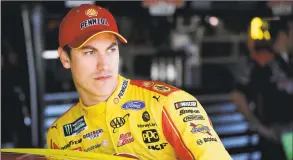  ?? Colin E. Braley / Associated Press ?? NASCAR driver Joey Logano climbs into his car to practice for a Cup Series auto race at Kansas Speedway in Kansas City, Kan., in 2019. Logano has establishe­d a $1 Million COVID-19 Response and Recovery Fund.