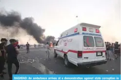  ?? —AFP ?? BAGHDAD: An ambulance arrives at a demonstrat­ion against state corruption in the Iraqi capital Baghdad.
