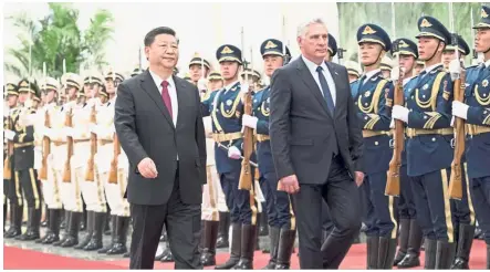  ??  ?? Renewing ties: Xi and Diaz- Canel reviewing an honour guard during a welcome ceremony at the Great Hall of the People in Beijing. — AP