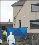  ??  ?? Police and forensics at the scene after the blaze in Kilmarnock