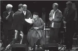  ?? PHOTO BY RICHARD SHOTWELL/INVISION/AP ?? JONI MITCHELL IS PRESENTED WITH A BIRTHDAY CAKE on stage at JONI 75: A Birthday Celebratio­n on Wednesday at the Dorothy Chandler Pavilion in Los Angeles.
