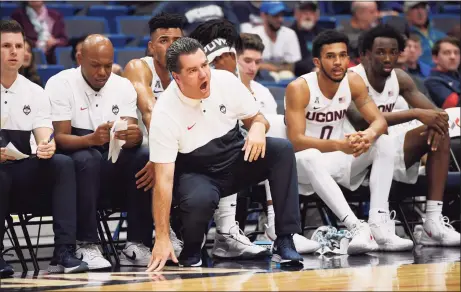  ?? Jessica Hill / Associated Press ?? UConn assistant coach Tom Moore calls out to the team during a 2019 exhibition in Storrs.