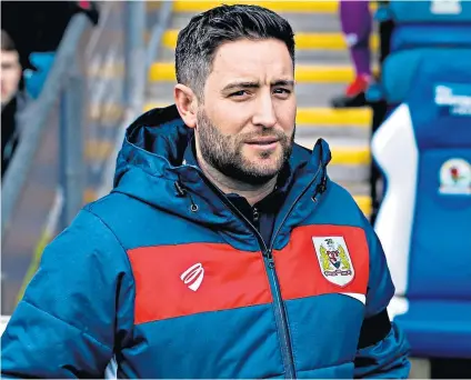  ??  ?? Headline-grabber: Lee Johnson hugs Joe Morrell (below) after Bristol City’s win over Bolton in the FA Cup fourth round