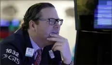  ?? Richard Drew/Associated Press ?? Specialist Gregg Maloney works on the floor of the New York Stock Exchange. Smaller companies, especially small banks, did better than the rest of the market on Wednesday.