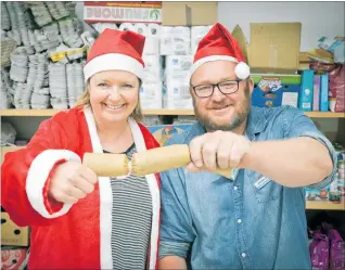  ??  ?? Tauranga Community Foodbank manager Nicki Goodwin and warehouse manager Brendon Collins get into the festive spirit as the Bay of Plenty Times Christmas Appeal begins.