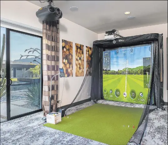  ?? Simply Vegas ?? The home has lots of entertainm­ent features, including this golf simulator.