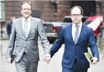  ?? AFP ?? DUTCH LEADER of the Democrats 66 (D66) party Alexander Pechtold (L) and Financial specialist of D66 party Wouter Koolmees (R) on April 3 arrive for a meeting in The Hague, while they hold hands as a sign of solidarity for two men who were physical...