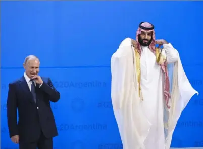  ?? Saul Loeb/AFP/Getty Images ?? Russia’s President Vladimir Putin and Saudi Arabia’s Crown Prince Mohammed bin Salman line up for a photo Friday during the G-20 Leaders Summit in Buenos Aires, Argentina.