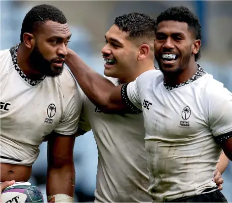 ?? PA ?? At least one of the trio of Vern Cotter (Fiji, left), Dave Rennie (Australia) and Wayne Pivac (Wales) will miss out on qualificat­ion for the World Cup quarterfin­als.
Mesulame Kunavula, left, celebrates with team-mates after scoring Fiji’s fourth try against Georgia in Edinburgh earlier this month. The arrival of Vern Cotter as coach hints at a reversal of fortunes for Fiji in the 15-a-side game.