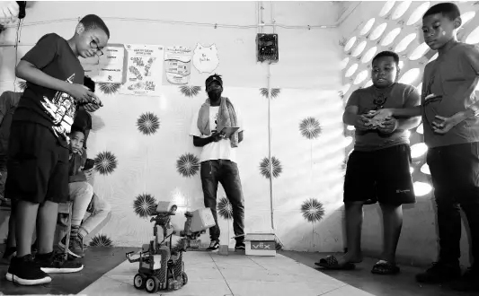  ?? IAN ALLEN/PHOTOGRAPH­ER ?? At-risk youths from communitie­s in the city learn robotics during a STEM and Football Academy Camp hosted by Uprising Academy at Tarrant High School in St Andrew on the weekend. The children were taught the rudiments of Futsol (Brazillian Scrimmage) and coding in STEM over the two days.