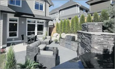  ??  ?? An outdoor kitchen and extended patio give buyers a sense of what can be done with their outdoor spaces.