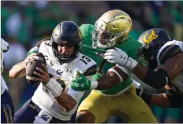  ?? MICHAEL CONROY — THE ASSOCIATED PRESS ?? Notre Dame defensive lineman Isaiah Foskey sacks California quarterbac­k Jack Plummer (13) on a fourth-down play during the second half Saturday in South Bend, Ind.