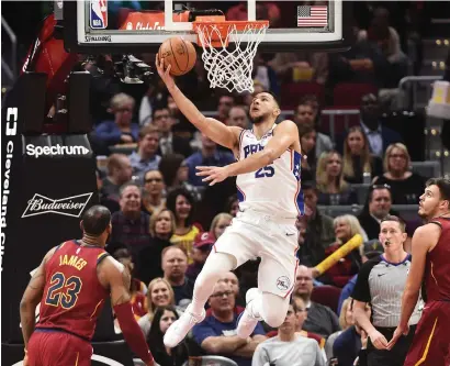  ?? Reuters ?? Philadelph­ia’s Ben Simmons (25) drives to the basket as Cavaliers forward LeBron James (23) and forward Ante Zizic (41) look on. —