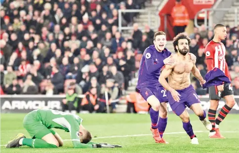  ?? — AFP photo ?? Liverpool's Egyptian midfielder Mohamed Salah (2nd R) celebrates with Liverpool's Scottish defender Andrew Robertson (C) after scoring their second goal against Southampto­n.